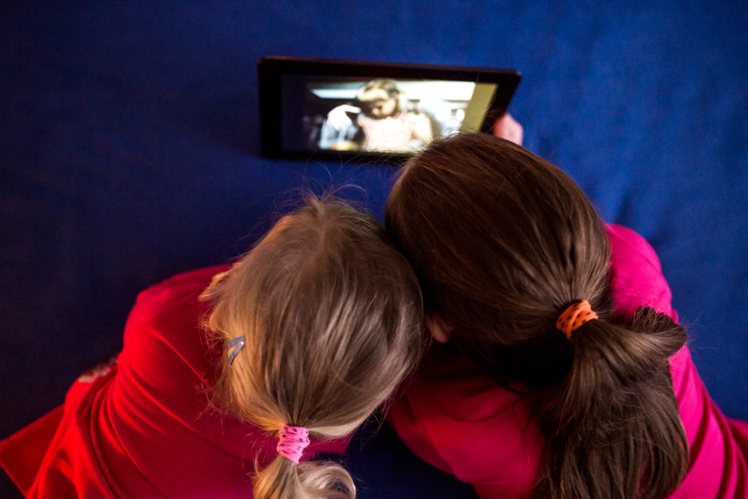 anonymous girls watching video tablet